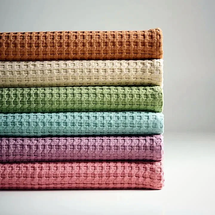 Waffle weave towel with tactile textured surface